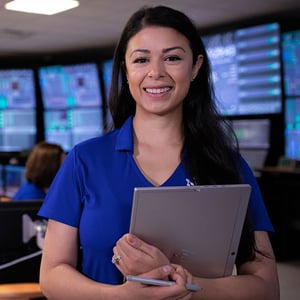 NuScale employee standing with clipboard in control room.