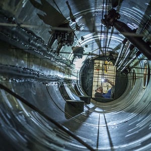 Worker inspecting interior of module.