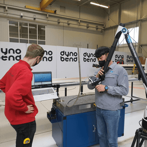 Two workers in industrial setting.