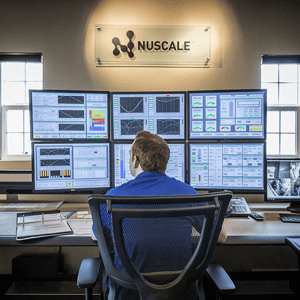 Person in front of six monitors.